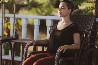 A woman meditating while sitting on a chair